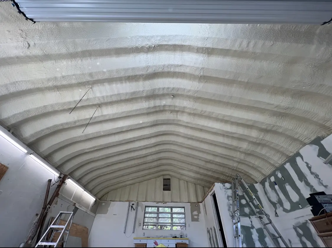 Spray polyurethane foam applied to the underside of a metal roof deck in Lorton